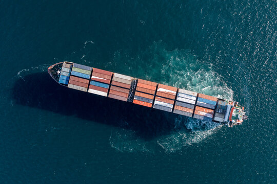 Sea Container Ship Is Moving At Sea. Around The Foam From The Work Of The Screw. View Of The Ship From Above.