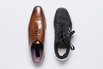 Formal and sports shoes on light background