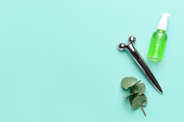 Face massage roller with essential oil on color background