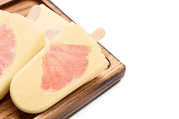 Board with tasty grapefruit ice cream on white background