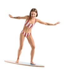 Beautiful young woman with surfboard on white background