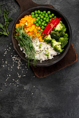 Bowl with rice, broccoli , pumpkin and microgreens.