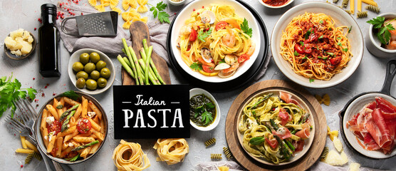 Pasta assortment on gray background.