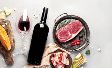 Red wine Primitivo with appetizers on gray background.