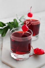 Glasses of tasty Manhattan cocktail on light background, closeup