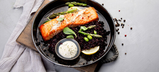Baked salmon with asparagus and black rice.