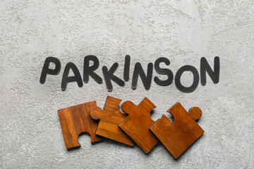 Word PARKINSON with puzzle pieces on grunge background