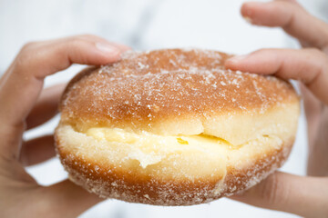 Close-up of Mexican bun filled with cream