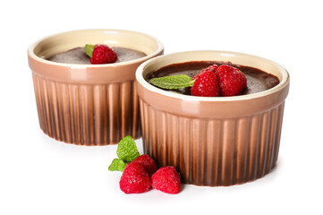 Ramekins with tasty lava cake fondant and raspberry on white background