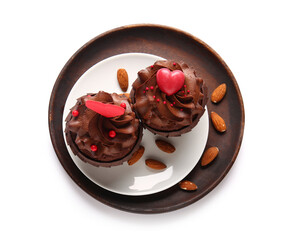 Plate with tasty chocolate cupcakes for Valentine's day and almond on white background