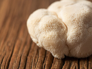 Hericium erinaceus mushroom on wooden background © mnimage