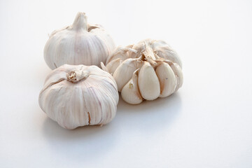 Three bulbs of garlic on a white background.