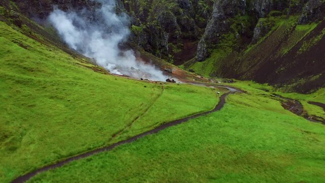 Rising Steams On Thermal River Of Reykjadalur Valley In South Coast Of Iceland. Aerial Drone