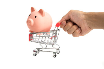 Pink piggy bank and shopping cart. The concept of saving money on shopping in the store
