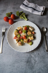 Healthy food item paneer or cottage cheese and vegetable salad served in a white plate. Top view. 