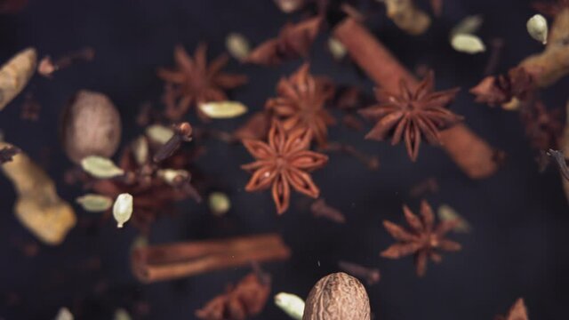 Super slow motion of flying Spices. Filmed in lack background