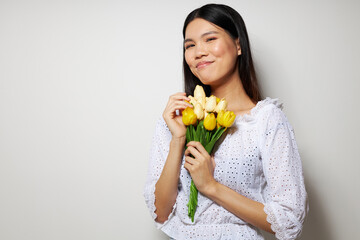 woman in a white shirt flowers spring posing light background unaltered
