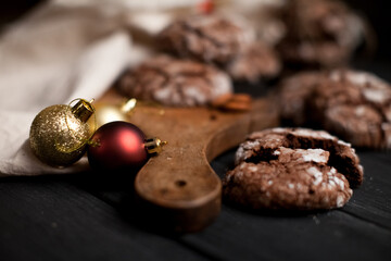 Chocolate chip cookies on the wooden table surrounded by decorations. Selective focus.