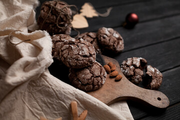 Chocolate chip cookies on the wooden table surrounded by decorations. Selective focus.