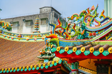 Colourful; red green blue yellow, Taiwan Dragon craft at the Lungshan Temple of Manka rooftop, Taipei, Taiwan and blur old building behind.