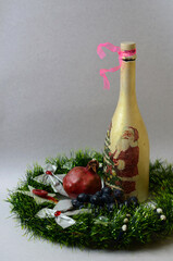 Wine bottle and fruit in a Christmas wreath.
