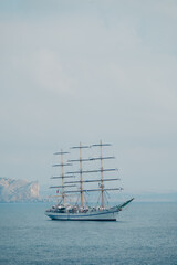 Fototapeta na wymiar Khersones frigate. beautiful large ancient ship (frigate) in the sea with low sails in sunny weather
