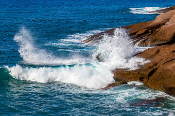 The waves of the Atlantic Ocean crash on rocks with splashes in Tenerife