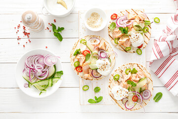 Spicy tacos with grilled salmon, vegetables, ricotta cheese, chili and fresh mint