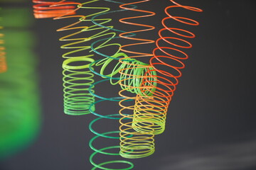 neon plastic spring toy hang on to ceiling for photo backdrop and vintage concept.