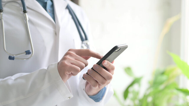 Close up of Doctor using Smartphone, Mobile