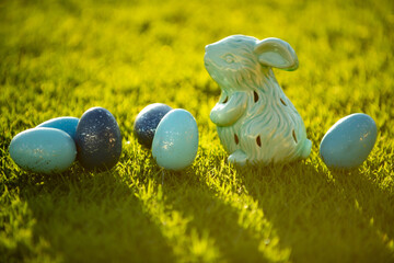 Easter eggs and bunny outdoor on grass background.