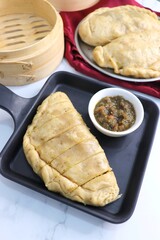Himachali Local dish siddu. It's a steamed stuffed bread. Made from wheat flour stuffed with split urad dal, dry fruits, poppy seeds, walnut etc. and enjoyed with desi ghee, tomato chutney. Copy space