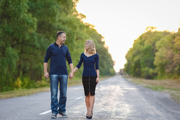Fototapeta premium A Happy couple in love on the road in the park on nature travel