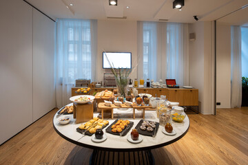 Breakfast served on a round buffet table in a hotel restaurant