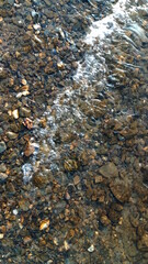 Close up view of smooth round pebble stones on the beach.