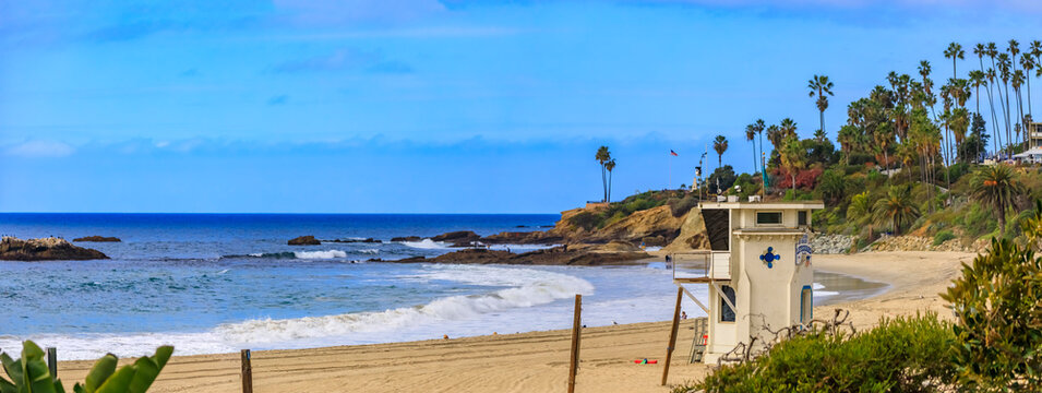 Beach and Pacific ocean in Laguna Beach, famous tourist destination in California, USA with a lifeguard station on a cloudy day