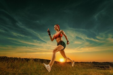 Fototapeta na wymiar Runner running on trail. Athlete sprinter run. Strong athletic woman running on black background wearing in the sportswear. Fitness and sport motivation. Runner concept.