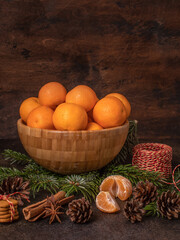 Christmas still life. Mandarins. Cinnamon, spruce branches, cones.