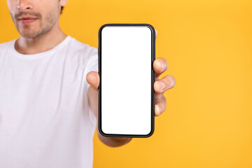 Man showing white empty smartphone screen close to camera