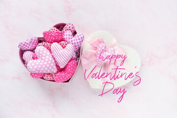 Happy Valentine's Day greeting card. soft textile hearts in gift box on abstract marble background. Set of striped, checkered fabric hearts - handmade cute decor, romantic gift for Valentine's day. 