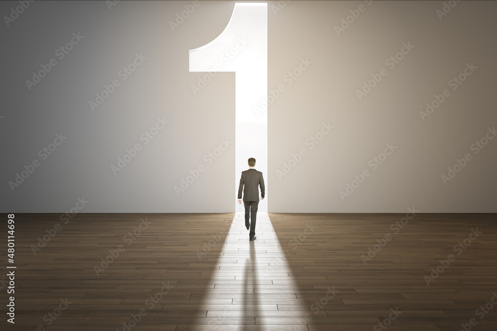 Poster back view of businessman in interior with concrete wall and wooden flooring walking towards abstract