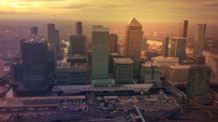 Naklejka na ściany i meble Aerial drone photo of iconic skyscraper banking and business complex of Canary Wharf at sunset, Docklands, London, United Kingdom