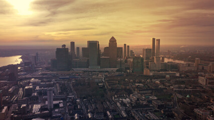 Naklejka na ściany i meble Aerial drone photo of iconic skyscraper banking and business complex of Canary Wharf at sunset, Docklands, London, United Kingdom