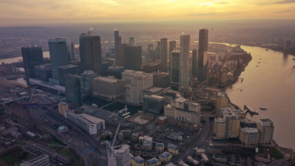 Aerial drone photo of iconic skyscraper banking and business complex of Canary Wharf at sunset, Docklands, London, United Kingdom