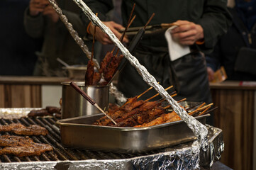 Christmas market in Cologne, Germany.
The booth selling traditional meat food at Cologne Christmas market.
