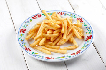 golden french fries on the wooden background