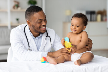 Portrait Of Black Doctor Making Medical Check Up For Little Baby Patient - obrazy, fototapety, plakaty