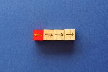 Top view image of arrow sign in opposite direction from others. Unique, think different, individual...