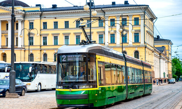 HELSINKI, FINLAND - JULY 3RD, 2017: Tram speeds up along the city streets.