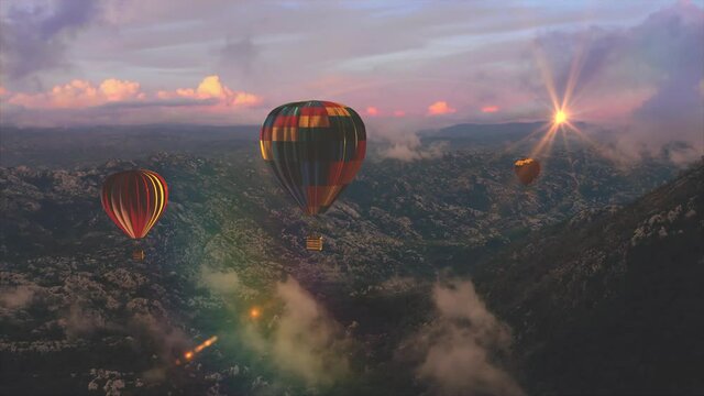Three hot air balloons flight above mountains on the sunset or sunrise.